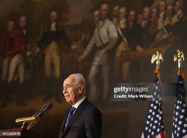 Israeli President Shimon Peres speaks after being presented with the Congressional Gold Medal during a ceremony at the U.S. Capitol, June 26, 2014 in...