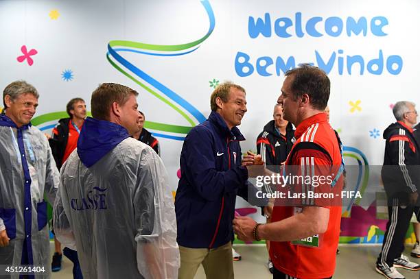 Head coach Jurgen Klinsmann of the United States greets Germany team staff Tim Meyer in the tunnel prior to the 2014 FIFA World Cup Brazil Group G...