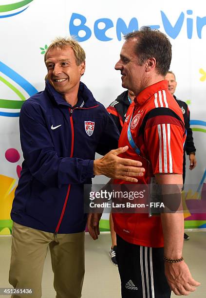 Head coach Jurgen Klinsmann of the United States greets Germany team staff Tim Meyer in the tunnel prior to the 2014 FIFA World Cup Brazil Group G...