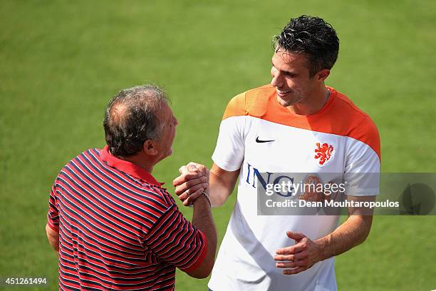 Robin van Persie speaks and shares a joke with Brazilian football Legend, Zico during the Netherlands training session at the 2014 FIFA World Cup...