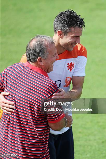 Robin van Persie speaks and shares a joke with Brazilian football Legend, Zico during the Netherlands training session at the 2014 FIFA World Cup...