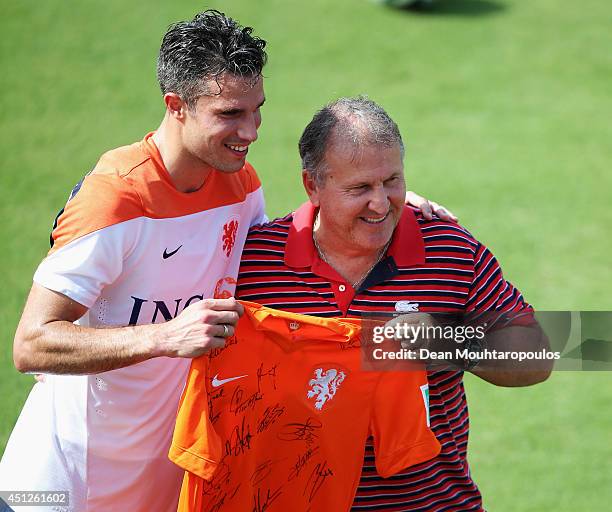 Robin van Persie poses with Brazilian football Legend, Zico as he is presented a signed Dutch shirt during the Netherlands training session at the...