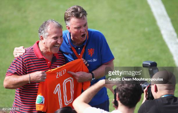 Head Coach, Louis van Gaal poses with Brazilian football Legend, Zico as he is presented a signed Dutch shirt during the Netherlands training session...
