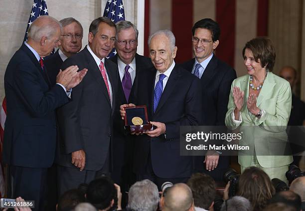 Israeli President Shimon Peres is presented with the Congressional Gold Medal during a ceremony at the U.S. Capitol, June 26, 2014 in Washington, DC....