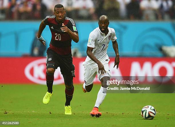 Jerome Boateng of Germany and DaMarcus Beasley of the United States compete for the ball during the 2014 FIFA World Cup Brazil group G match between...