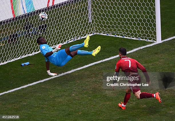 Goalkeeper Fatawu Dauda of Ghana makes a save at a header at goal by Cristiano Ronaldo of Portugal during the 2014 FIFA World Cup Brazil Group G...