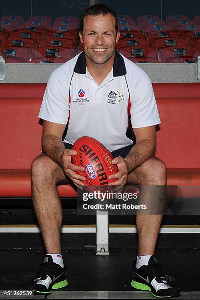 Academy high performance coach Brad Johnson poses for a photograph during a 2013 NAB AFL Draft media session at Metricon Stadium on November 22, 2013...