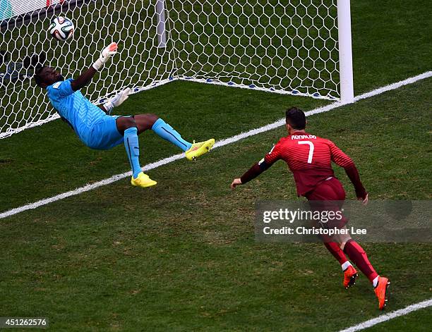 Goalkeeper Fatawu Dauda of Ghana makes a save at a header at goal by Cristiano Ronaldo of Portugal during the 2014 FIFA World Cup Brazil Group G...