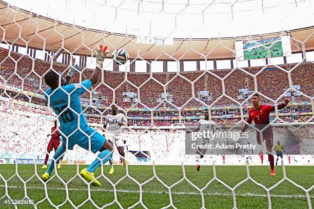 Goalkeeper Fatawu Dauda of Ghana makes a save at a header at goal by Cristiano Ronaldo of Portugal during the 2014 FIFA World Cup Brazil Group G...