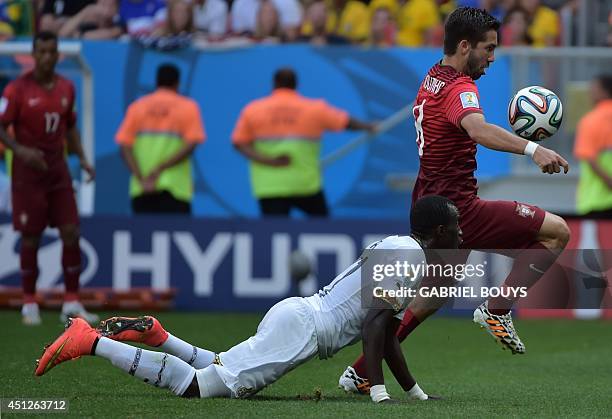 Ghana's midfielder Mohammed Rabiu and Portugal's midfielder Joao Moutinho vie during the Group G football match between Portugal and Ghana at the...