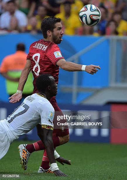 Ghana's midfielder Mohammed Rabiu and Portugal's midfielder Joao Moutinho vie during the Group G football match between Portugal and Ghana at the...