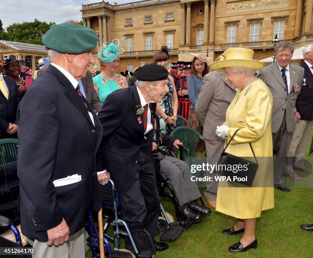 Queen Elizabeth II talks to a veteran as she attends the 'Not Forgotten' Association Garden Party, for the charity that helps ex service personnel at...