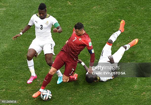 Ghana's forward and captain Asamoah Gyan, Portugal's forward and captain Cristiano Ronaldo and Ghana's midfielder Mohammed Rabiu vie for the ball...