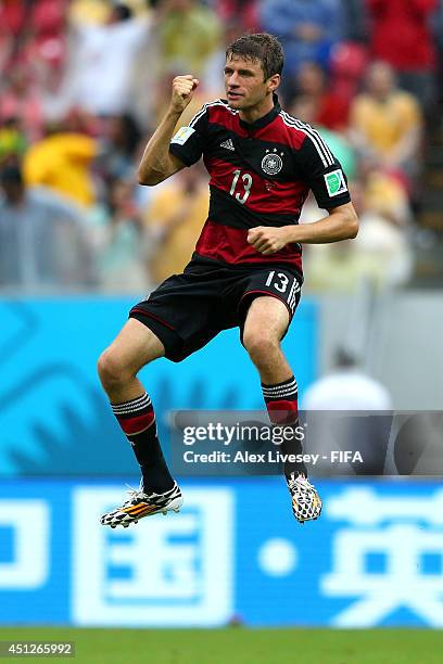 Thomas Mueller of Germany celebrates scoring his team's first goal during the 2014 FIFA World Cup Brazil Group G match between USA and Germany at...