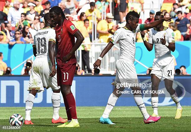 Ghana's forward and captain Asamoah Gyan celebrates with his temmates after scoring a goal during the Group G football match between Portugal and...
