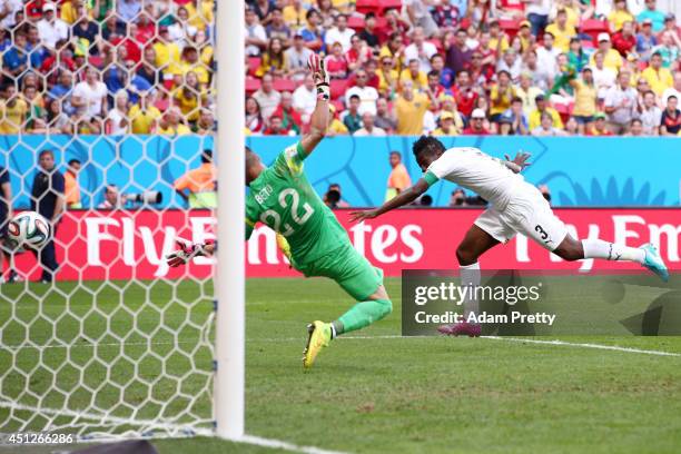 Asamoah Gyan of Ghana scores his team's first goal past goalkeeper Beto of Portugal during the 2014 FIFA World Cup Brazil Group G match between...