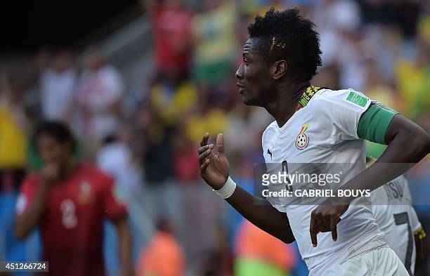 Ghana's forward and captain Asamoah Gyan celebrates scoring with his teammates during the Group G football match between Portugal and Ghana at the...