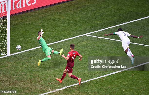 Asamoah Gyan of Ghana scores his team's first goal past goalkeeper Beto of Portugal during the 2014 FIFA World Cup Brazil Group G match between...