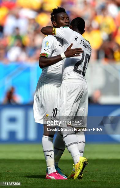 Asamoah Gyan of Ghana celebrates scoring his team's firs goal with his teammate Kwadwo Asamoah during the 2014 FIFA World Cup Brazil Group G match...