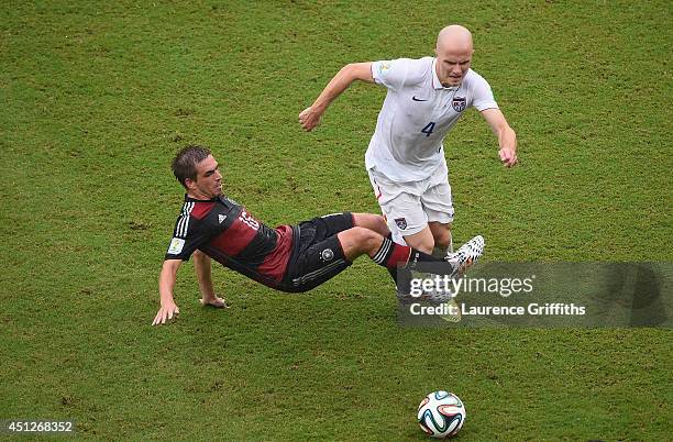 Philipp Lahm of Germany challenges Michael Bradley of the United States during the 2014 FIFA World Cup Brazil group G match between the United States...