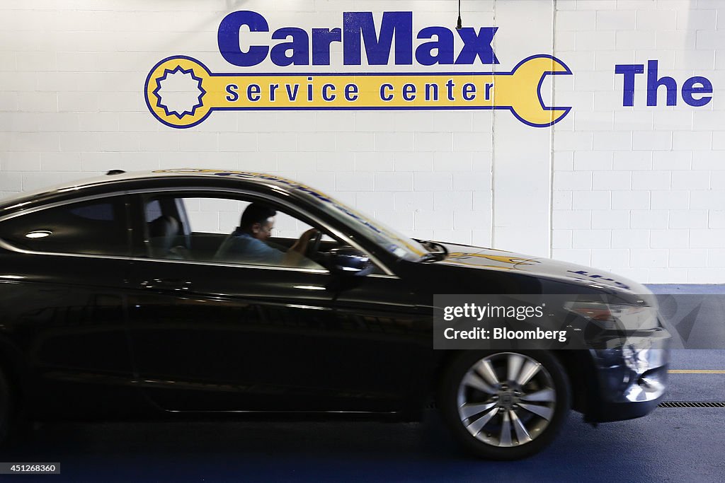 Carmax Service A car drives past signage for the service center of a CarMax Inc ...