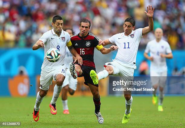 Philipp Lahm of Germany is challenged by Clint Dempsey and Alejandro Bedoya of the United States during the 2014 FIFA World Cup Brazil group G match...