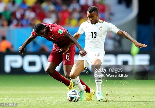 William Carvalho of Portugal and Jordan Ayew of Ghana compete for the ball during the 2014 FIFA World Cup Brazil Group G match between Portugal and...
