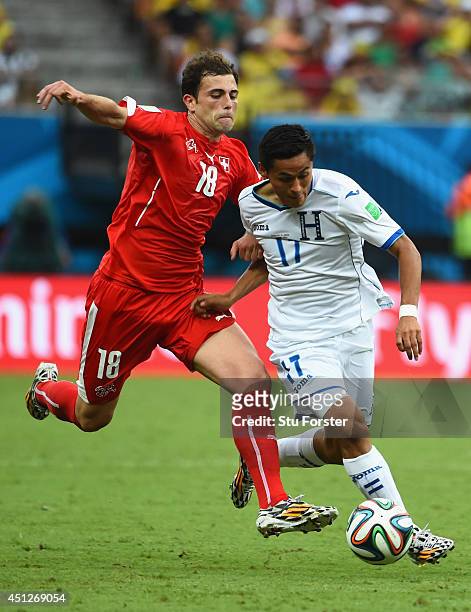 Andy Najar of Honduras is challenged by Admir Mehmedi of Switzerland during the 2014 FIFA World Cup Brazil Group E match between Honduras and...