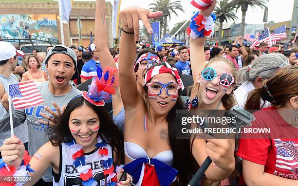Soccer fans celebrate as the USA qualifies to the round of 16 as they watch the match at Hermosa Beach, California, on June 26, 2014 the USA-Germany...