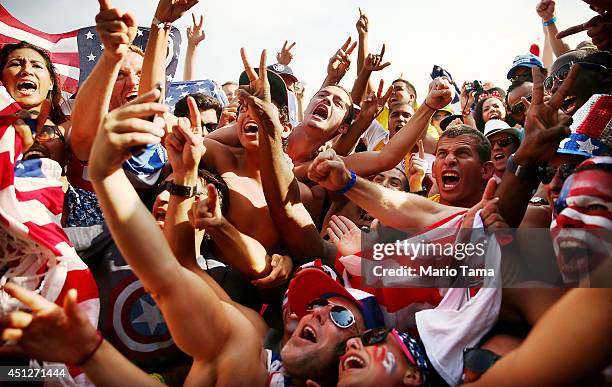 Supporters celebrate advancing to the Round of 16 after their loss to Germany while watching the match at FIFA Fan Fest on June 26, 2014 in Rio de...