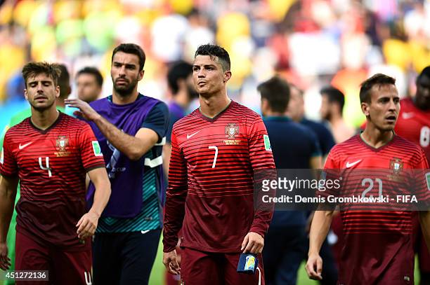 Miguel Veloso of Portugal, Cristiano Ronaldo of Portugal and Joao Pereira of Portugal show their dejection after the 2014 FIFA World Cup Brazil Group...
