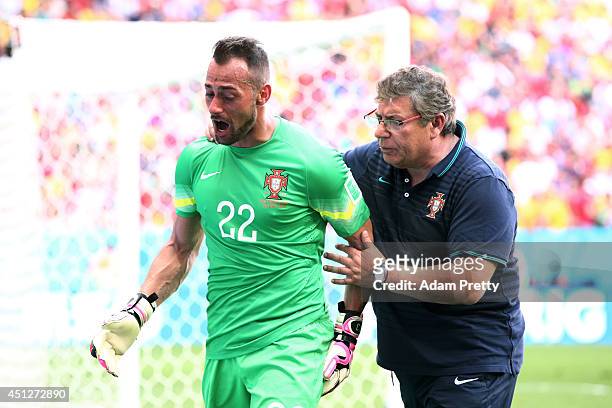 Goalkeeper Beto of Portugal receives assistance during the 2014 FIFA World Cup Brazil Group G match between Portugal and Ghana at Estadio Nacional on...