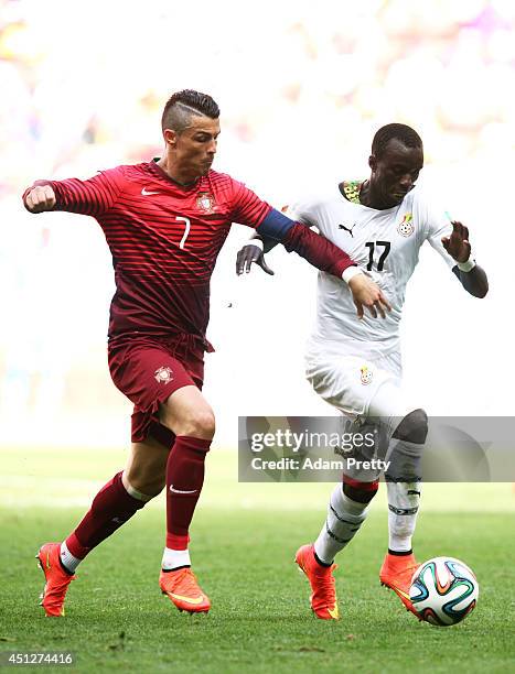 Cristiano Ronaldo of Portugal and Mohammed Rabiu of Ghana compete for the ball during the 2014 FIFA World Cup Brazil Group G match between Portugal...