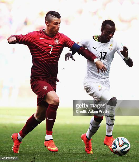 Cristiano Ronaldo of Portugal challanges Mohammed Rabiu of Ghana during the 2014 FIFA World Cup Brazil Group G match between Portugal and Ghana at...