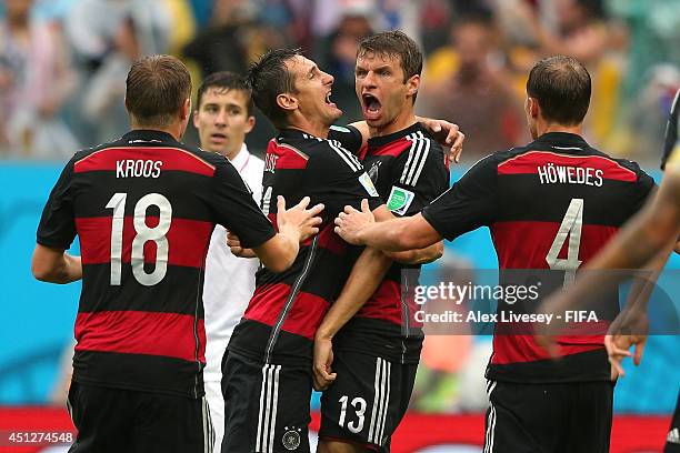 Thomas Mueller of Germany celebrates scoring his team's first goal with his teammates Benedikt Hoewedes , Miroslav Klose and Toni Kroos during the...