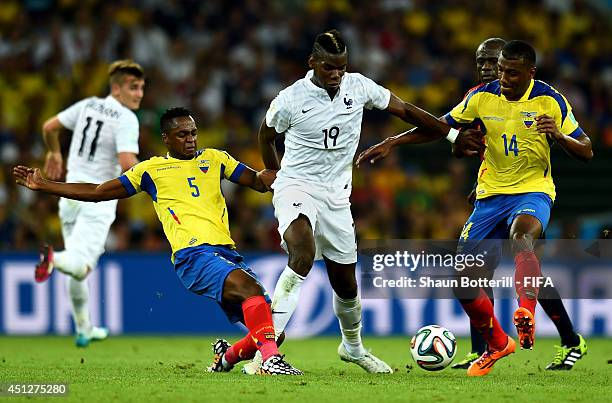 Paul Pogba of France is challenged by Alex Ibarra and Oswaldo Minda of Ecuador during the 2014 FIFA World Cup Brazil Group E match between Ecuador...