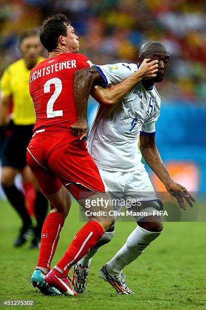 Stephan Lichtsteiner of Switzerland and Jerry Palacios of Honduras tussle during the 2014 FIFA World Cup Brazil Group E match between Honduras and...