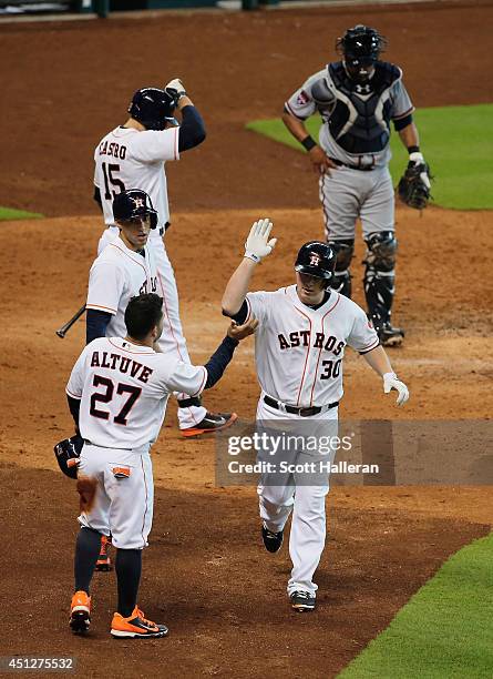 Jose Altuve of the Houston Astros greets Matt Dominguez after Dominguez hit a three-run home run in the fifth inning during their game against the...