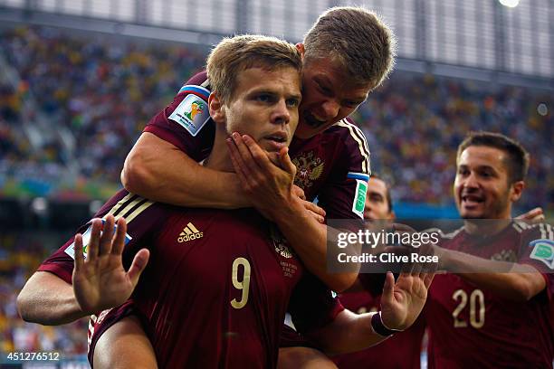 Alexander Kokorin of Russia celebrates scoring his team's first goal with teammate Oleg Shatov on his back during the 2014 FIFA World Cup Brazil...