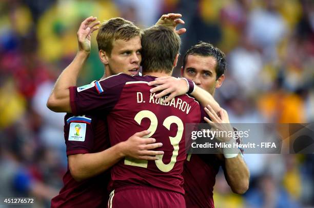 Alexander Kokorin of Russia celebrates scoring his team's first goal with his teammate Dmitry Kombarov and Aleksandr Kerzhakov during the 2014 FIFA...