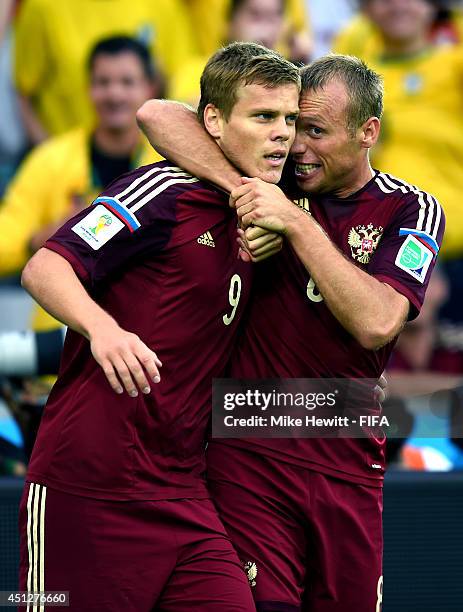 Alexander Kokorin of Russia celebrates scoring his team's first goal with his teammate Denis Glushakov of Russia during the 2014 FIFA World Cup...