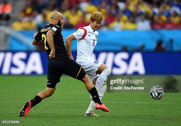 Anthony Vanden Borre of Belgium and Son Heung-Min of South Korea compete for the ball during the 2014 FIFA World Cup Brazil Group H match between...