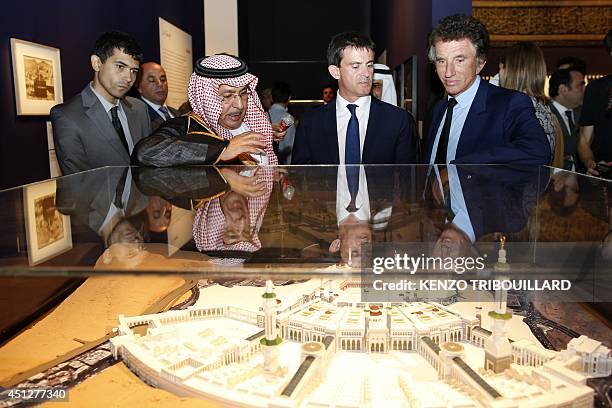 French Prime minister Manuel Valls and President of the Arab World Institute Jack Lang look at an installation part of the exhibition "Hajj, the...