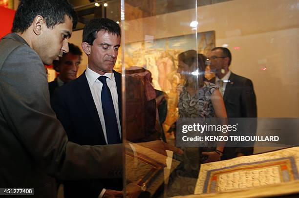 French Prime minister Manuel Valls listens to an explanation about an item part of the exhibition "Hajj, the pilgrimage to Mecca" , on June 26, 2014...