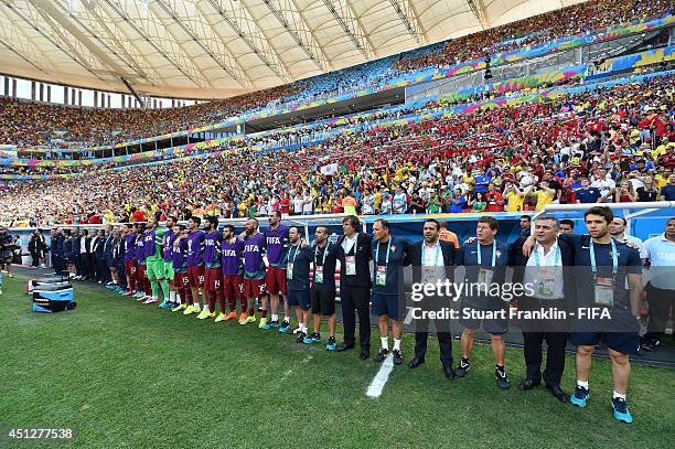 Substitute players and team staffs line up for the national anthems prior to the 2014 FIFA World Cup Brazil Group G match between Portugal and Ghana...