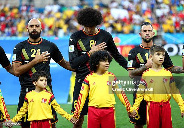 Anthony Vanden Borre, Marouane Fellaini and Steven Defour of Belgium look on prior to the 2014 FIFA World Cup Brazil Group H match between South...