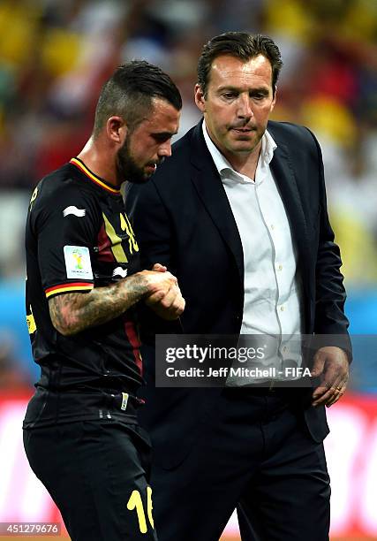 Steven Defour of Belgium of Belgium shakes hands with head coach Marc Wilmots as he walks off the pitch as he receives a red card during the 2014...