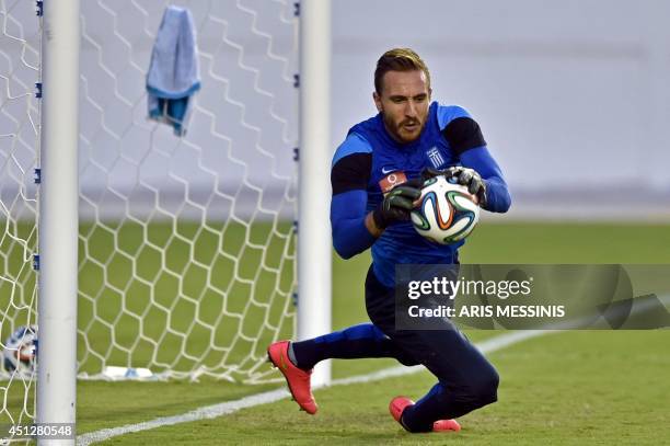 Greece's goalkeeper Panagiotis Glykos catches the ball during a training session in Aracaju, Brazil on June 27 ahead the 2014 FIFA World Cup match...