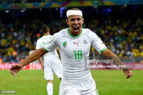 Sofiane Feghouli of Algeria celebrates his team's first goal scored by Islam Slimani during the 2014 FIFA World Cup Brazil Group H match between...