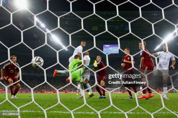 Islam Slimani of Algeria scores his team's first goal on a header past Igor Akinfeev of Russia during the 2014 FIFA World Cup Brazil Group H match...